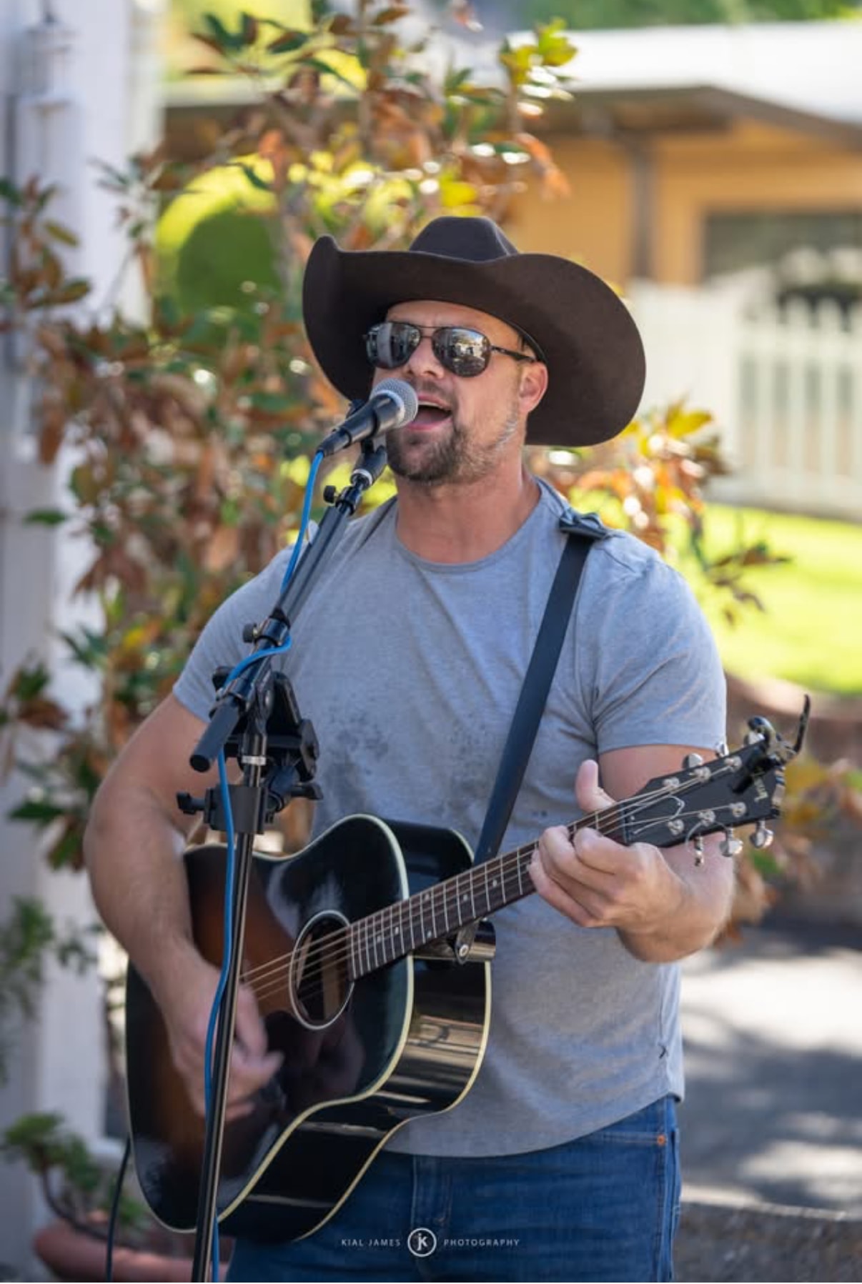 Folk duo playing on a decorated porch in autumn